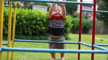 Baby toddler playing at monkey bars