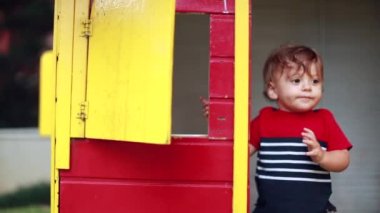 Toddler baby playing at playground house, infant falling down to the ground