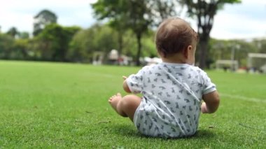 Baby todlder siting on grass park