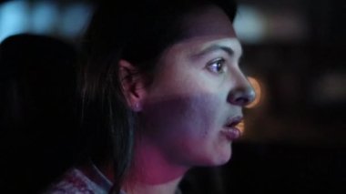Woman driving at night in slow-motion in city