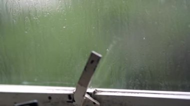 Rainy day window. Droplets falling during storm