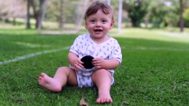 Cute baby crawling towards camera outside in nature