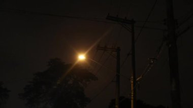 Passenger POV of lamp post light passing by at night in city