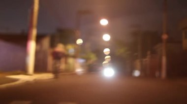 Blurred city at night sidewalk passing by