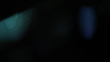 Defocused blurred city passing by at night in bokeh