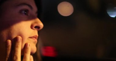 Profile of female driver in city at night. Woman driving in urban night
