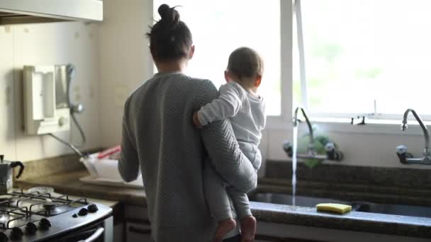 Mother Holding Baby Multi Tasking Kitchen Parent Multitasker — Vídeo de Stock