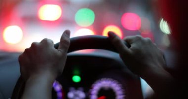 Driver stopped in traffic holding steering wheel