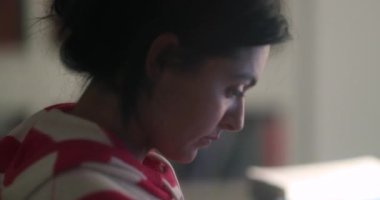 Female student taking notes late at night working