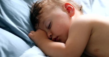 Cute baby napping in bed, adorable infant one year old child asleep