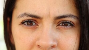 Concerned woman with worries look face, macro close-up of girl eye looking to camera frustrated