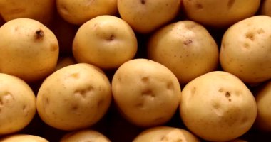 Pile of potatoes gathered together at grocery on display