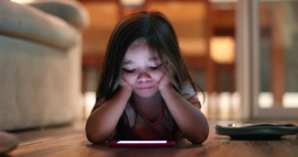 Little Girl Lying Floor Home Looking Smartphone Screen Cellphone Light — Stok video