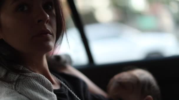 Mother Back Seat Taxi Looking Out Window Daydreaming Breastfeeding Baby — Stock Video