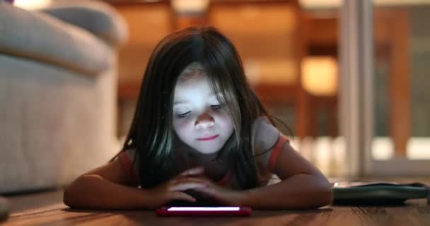 Child Girl Lying Hardwood Floor Night Watching Cellphone Screen — Stock videók