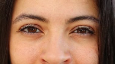 Pensive Woman opening and closing eyes macro closeup