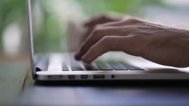 Hands typining on laptop. Closeup hand types on computer keyboard with depth of field