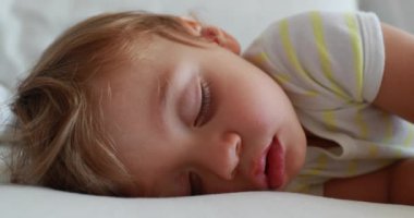 Baby face sleeping, infant child asleep dreaming. One year old toddler boy napping