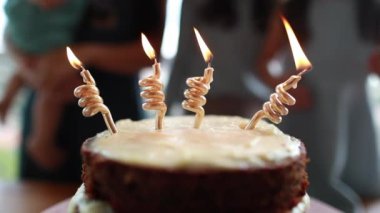 Birthday cake with blurred people in background