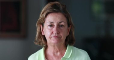 Senior woman portrait face looking to camera feeling shy