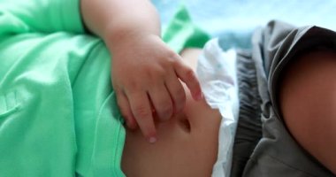 Baby napping close-up hand and belly