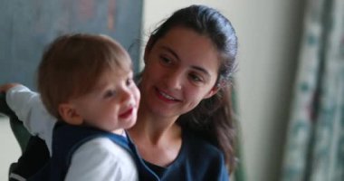 Casual mother and baby together at home. Mom and one year old toddler relationship