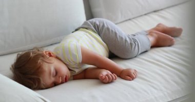 One year old toddler asleep, baby napping candid