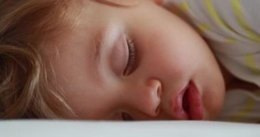 Baby sleeping. Cute infant face close-up asleep. Adorable one year old toddler boy napping macro closeup