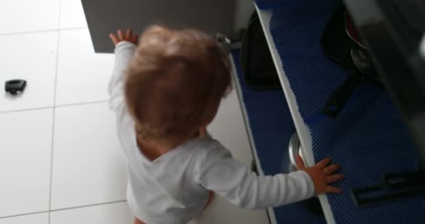 Baby Opening Kitchen Closet Grabbing Utensils — Stok Video