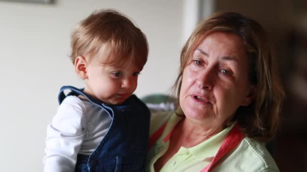 Grandmother Holding Grandson Baby Arms Casual Candid Senior Grandma Grandchild — стоковое видео