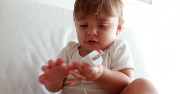 Baby Unplugging Smartphone Cable Toddler Boy Unplugs Cellphone Device Connector — Videoclip de stoc