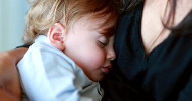 Baby sleeping in mother arms. Infant child asleep in afternoon nap