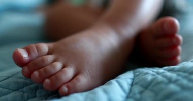 Baby toddler feet close-up in bed sleeping