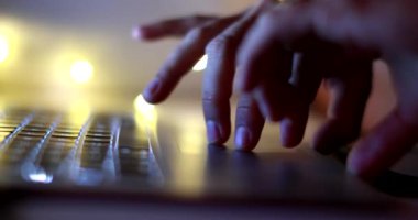 hand scrolling online laptop at night