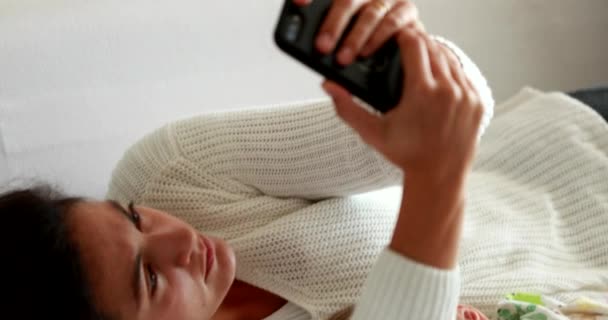 Woman Using Cellphone Lying Couch Home — Stockvideo