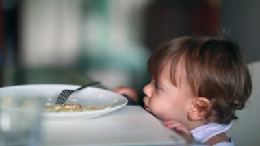 Adorable baby boy at lunch table waiting for food. toddler infant child at meal time