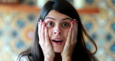 Woman shock reaction looking at camera, casual happy attractive woman with surprise reaction