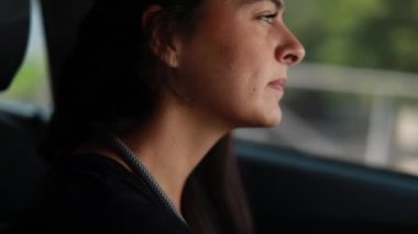 Woman portrait driving car, pensive close-up casual female driver