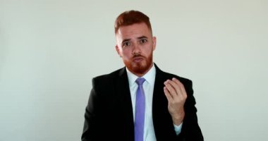 Angry redhair business man arguing to camera