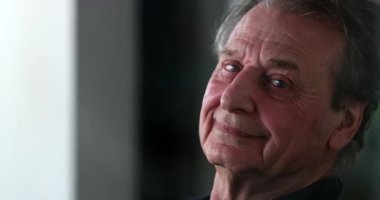 Smiling happy older man portrait looking at camera