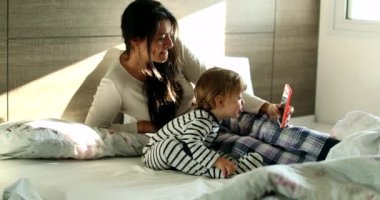 Mother and baby child in video chat with family on cellphone device