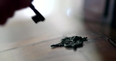 Close-up hand putting key in antique furniture