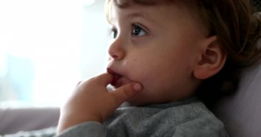 Toddler child face hypnotized by screen off-camera