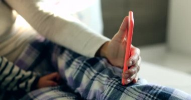 Mother and baby in front of cellphone screen in bed in the morning. Mom and toddler talking to family member