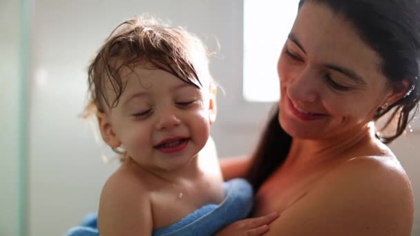 Cute Baby Blinking Camera Shower Held Mother — 图库视频影像