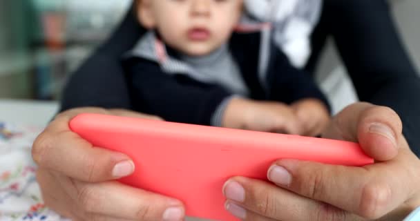 Close Mother Hands Holding Cellphone Watching Content Online Toddler Child — Vídeos de Stock