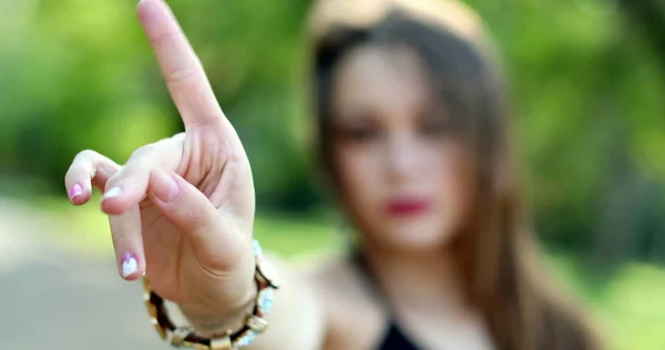 Millennial girl signalling to STOP with hand, woman waving finger gesture