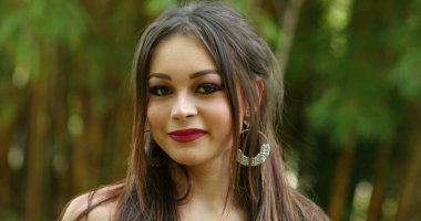 Güzel milenyum kızı gülümsüyor. Kameraya bakan genç kadın portresi