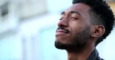 Contemplative young African black man eyes closed in mindful meditation