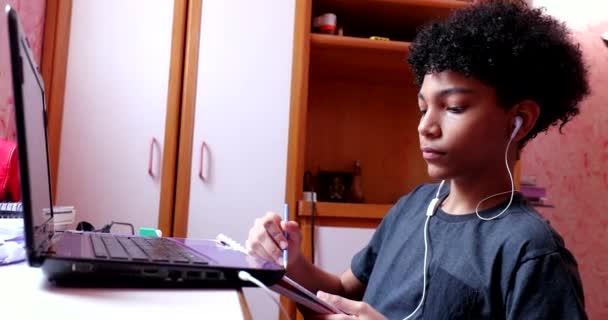 Mixed Race Kids Doing Homework Home Writing Notepad Looking Laptop — Stockvideo